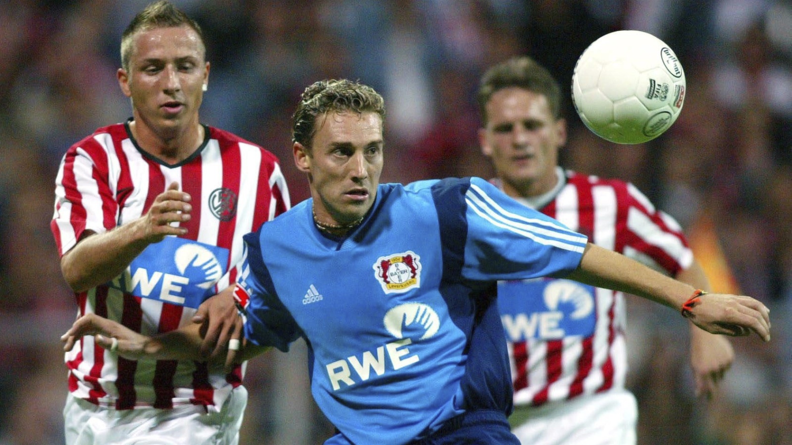 Das bislang letzte Duell im DFB-Pokal zwischen Rot-Weiss Essen und Bayer Leverkusen (blaue Trikots) gab es in der Saison 2002/2003. Hier kämpfen der Essener Ronny Ernst (links) und der Leverkusener Jan Simak um den Ball. Im Hintergrund: Der spätere RWE-Cheftrainer Heiko Bonan.